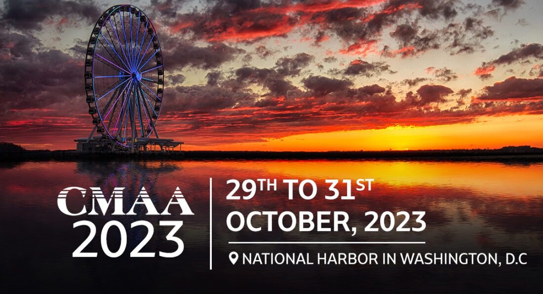 A promotional image for the CMAA 2023 event shows a scenic sunset view over calm waters with a large illuminated Ferris wheel on the left and text announcing the event dates "29th to 31st October, 2023" at National Harbor in Washington, D.C