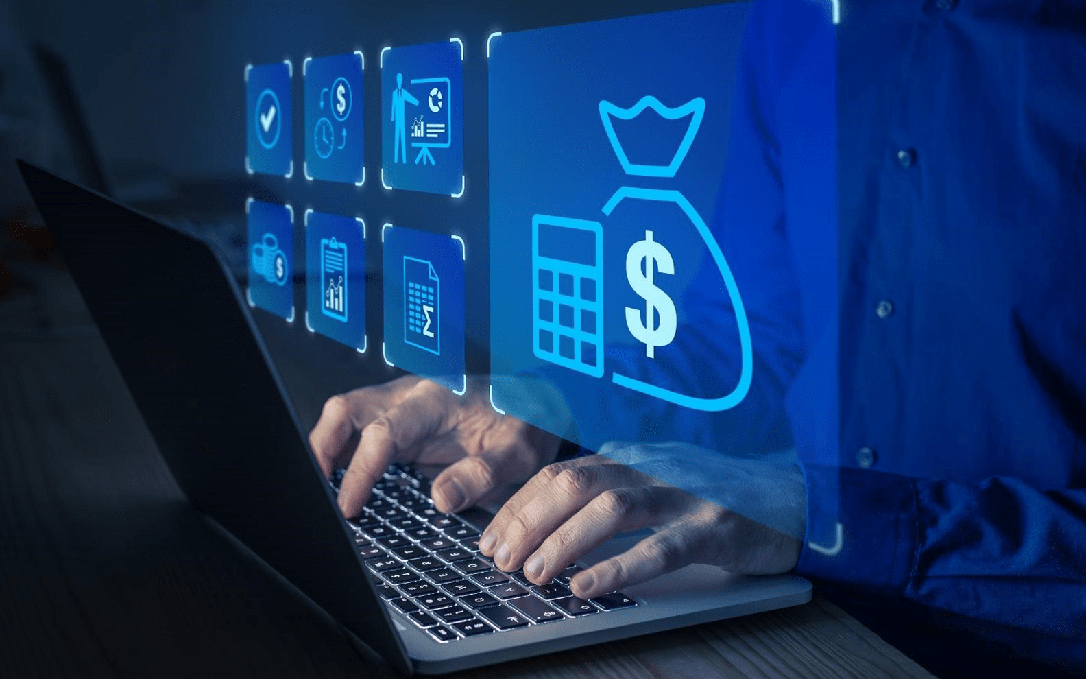 Person in a blue shirt using a laptop with holographic images of financial icons floating above the keyboard.